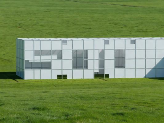 Large modern temporary event structure at dusk with interior lighting